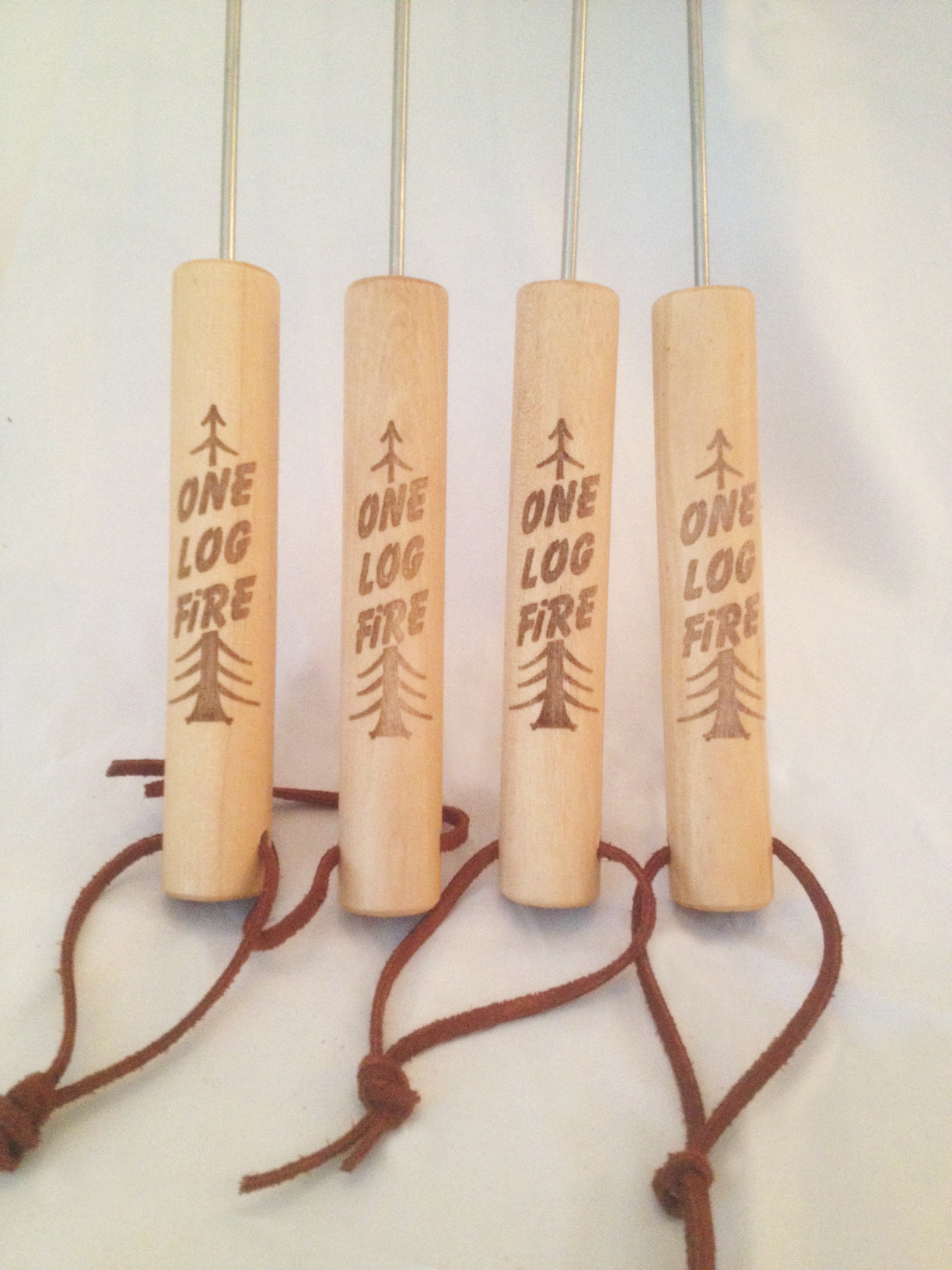 Four wooden marshmallow roasting sticks bundled together