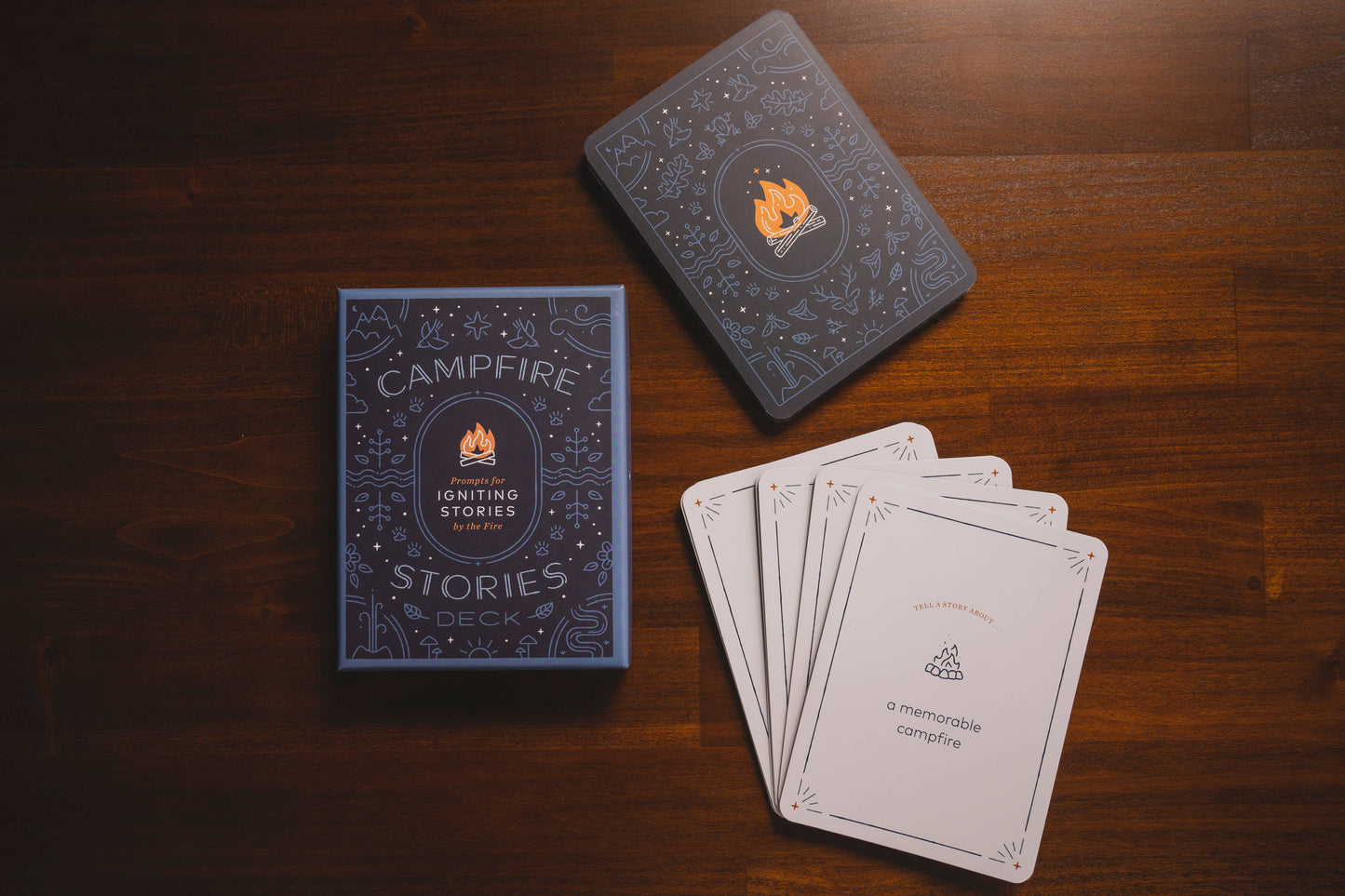 Card game set with 'Campfire Stories Deck' on a wooden surface